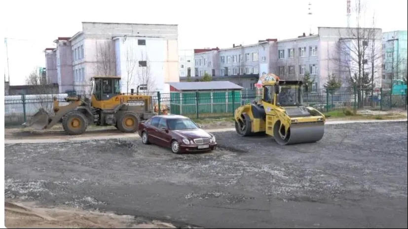 Дорожникам не удалось найти владельца авто, поэтому его осторожно обошли при асфальтировании парковки. Фото: Ольга Климова/«Ямал-Медиа»